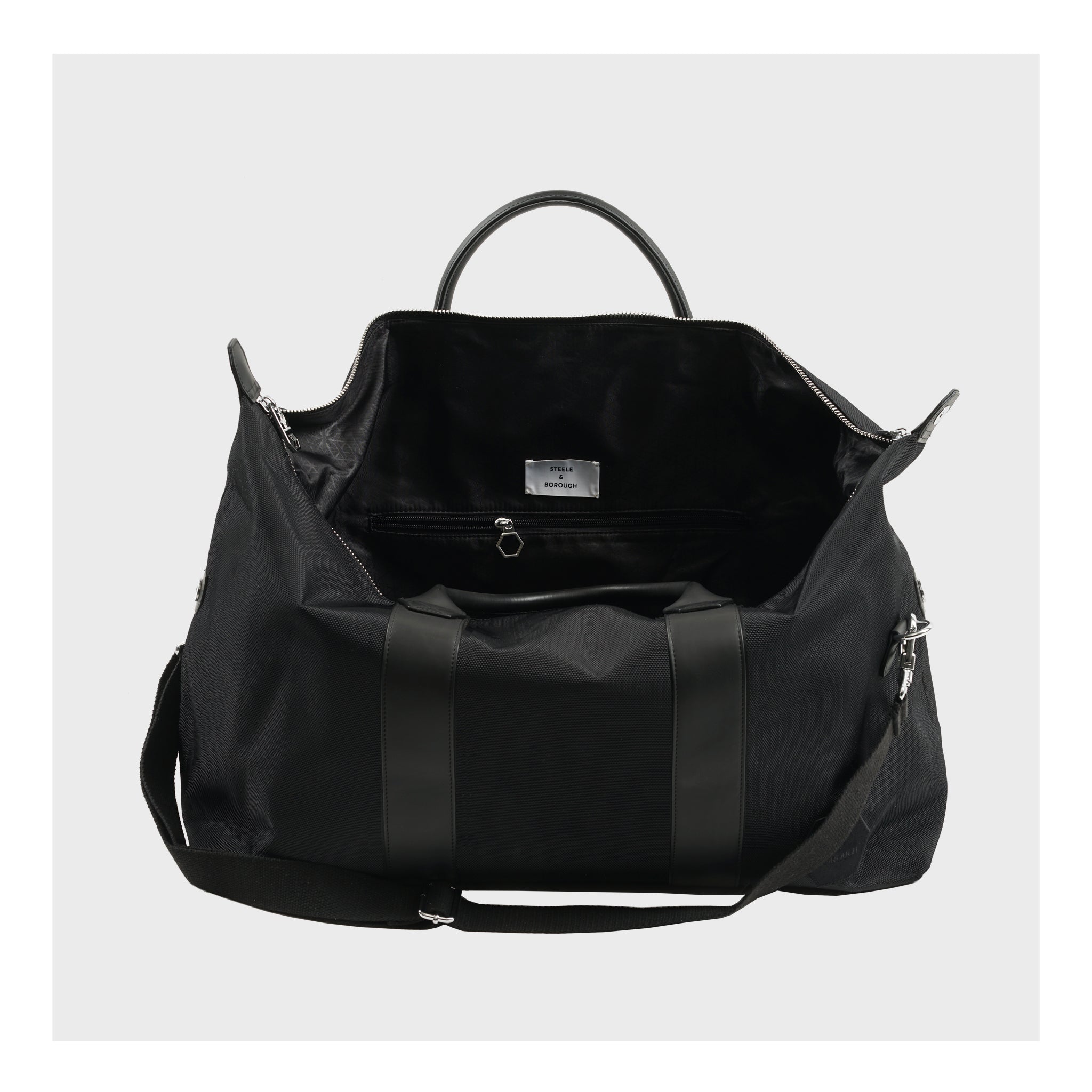 Interior view of the black Weekend Bag, displaying the spacious compartment and internal pockets