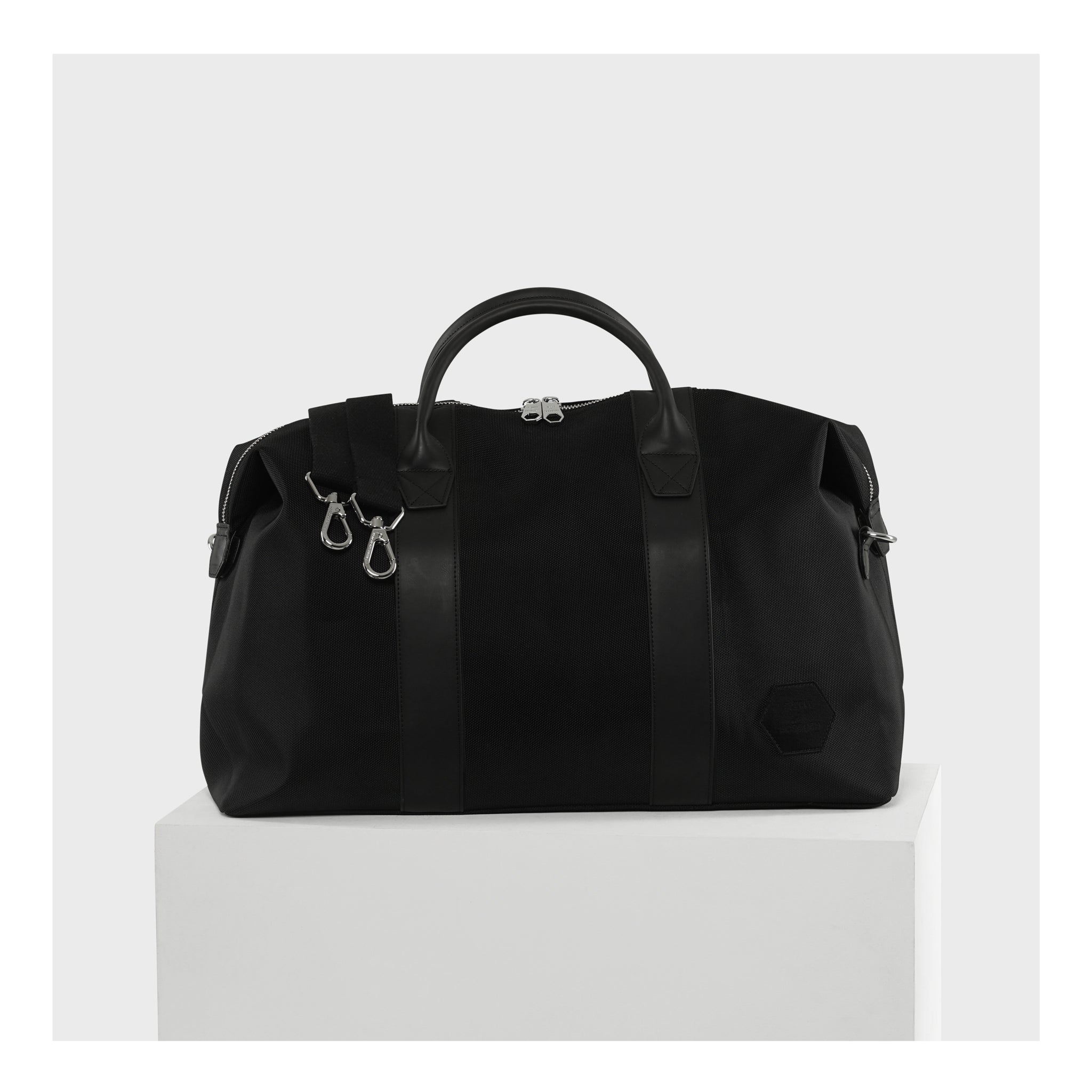 "Black Weekend Bag elegantly presented on a podium, perfect for discerning travelers who value sophistication