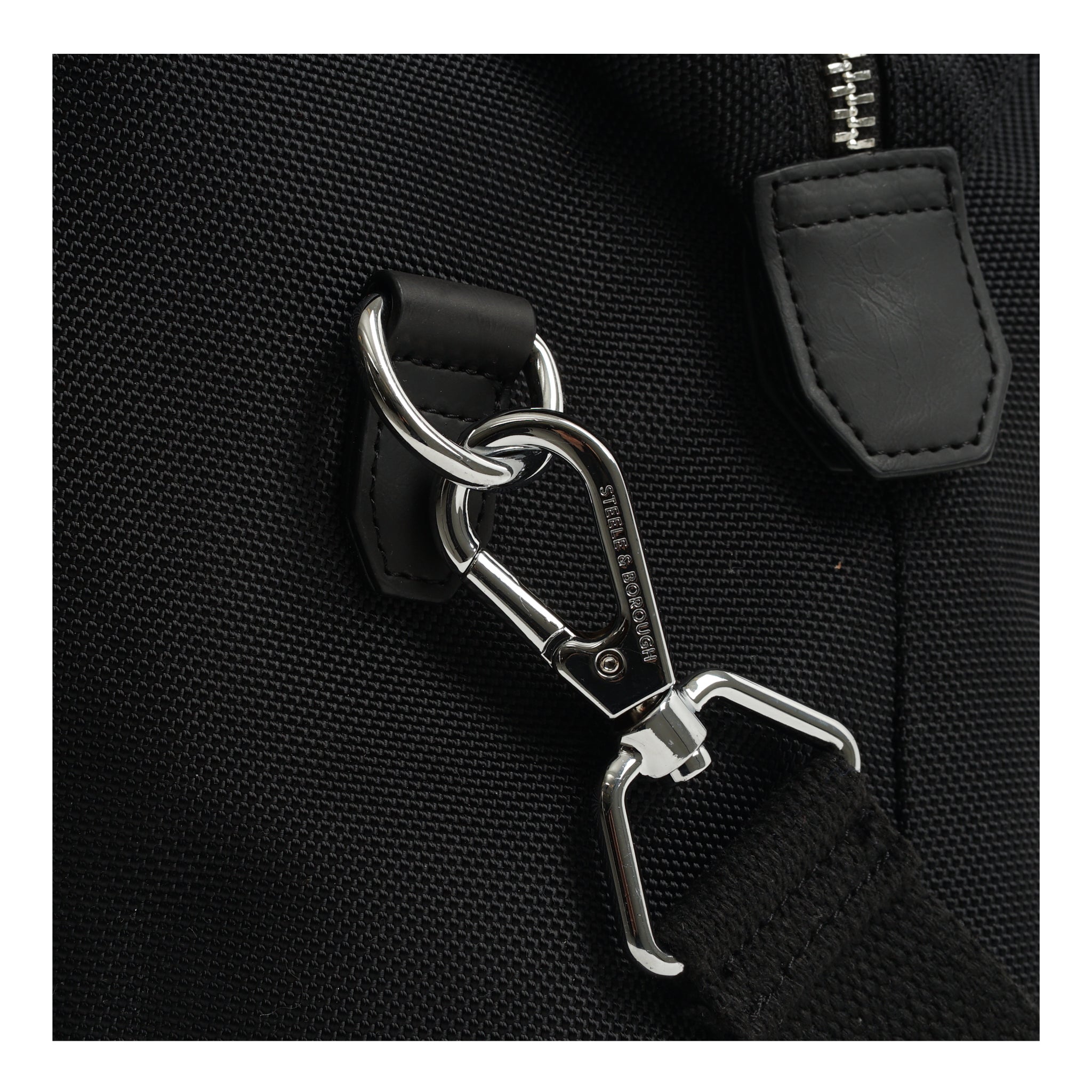Detailed view of the black Weekend Bag's hook and clasp, highlighting the secure and stylish hardware