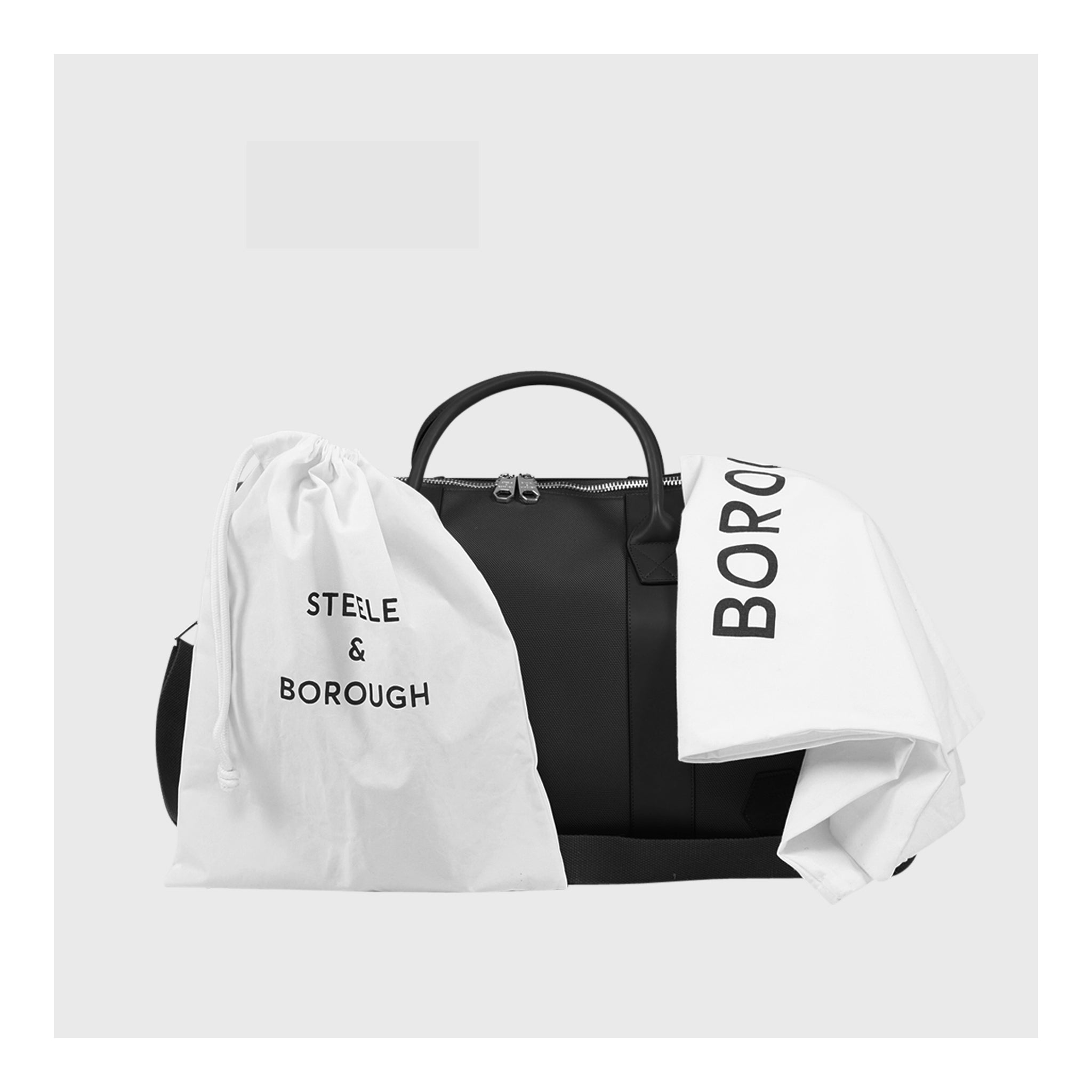 Black Weekend Bag paired with a protective white dust bag, merging luxury with practicality